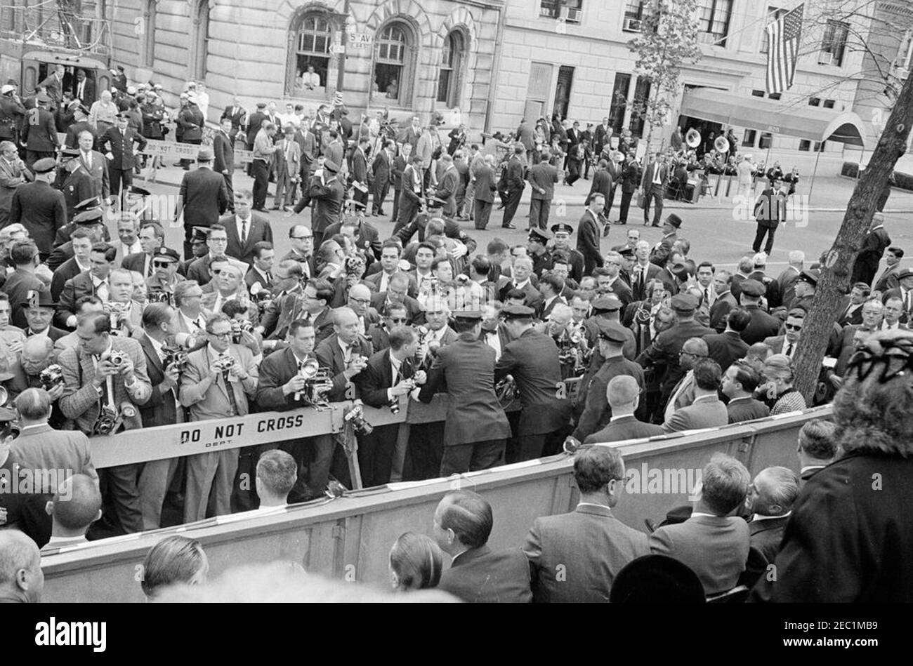 Congressional campaign trip: New York City, Columbus Day parade. View of news photographers on Fifth Avenue in New York City, New York, during the Columbus Day Parade. President John F. Kennedy visits with Ambassador of Italy, Sergio Fenoaltea, at lower right. Also pictured: Mayor of New York City, Robert F. Wagner; candidate for Governor of New York, Robert Morgenthau; Governor of New York, Nelson A. Rockefeller; Associate Press Secretary, Andrew T. Hatcher; United Press International (UPI) photographer, Frank Cancellare. President Kennedy traveled to New York as part of a congressional campa Stock Photo