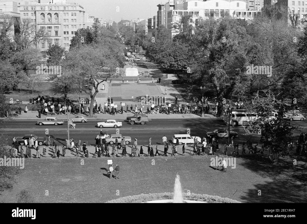 Demonstrators at the White House. View of demonstrators picketing along Pennsylvania Avenue in Washington, D.C., in response to the crisis in Cuba. The North Lawn of the White House is in the foreground; Lafayette Square is visible in the background. Stock Photo