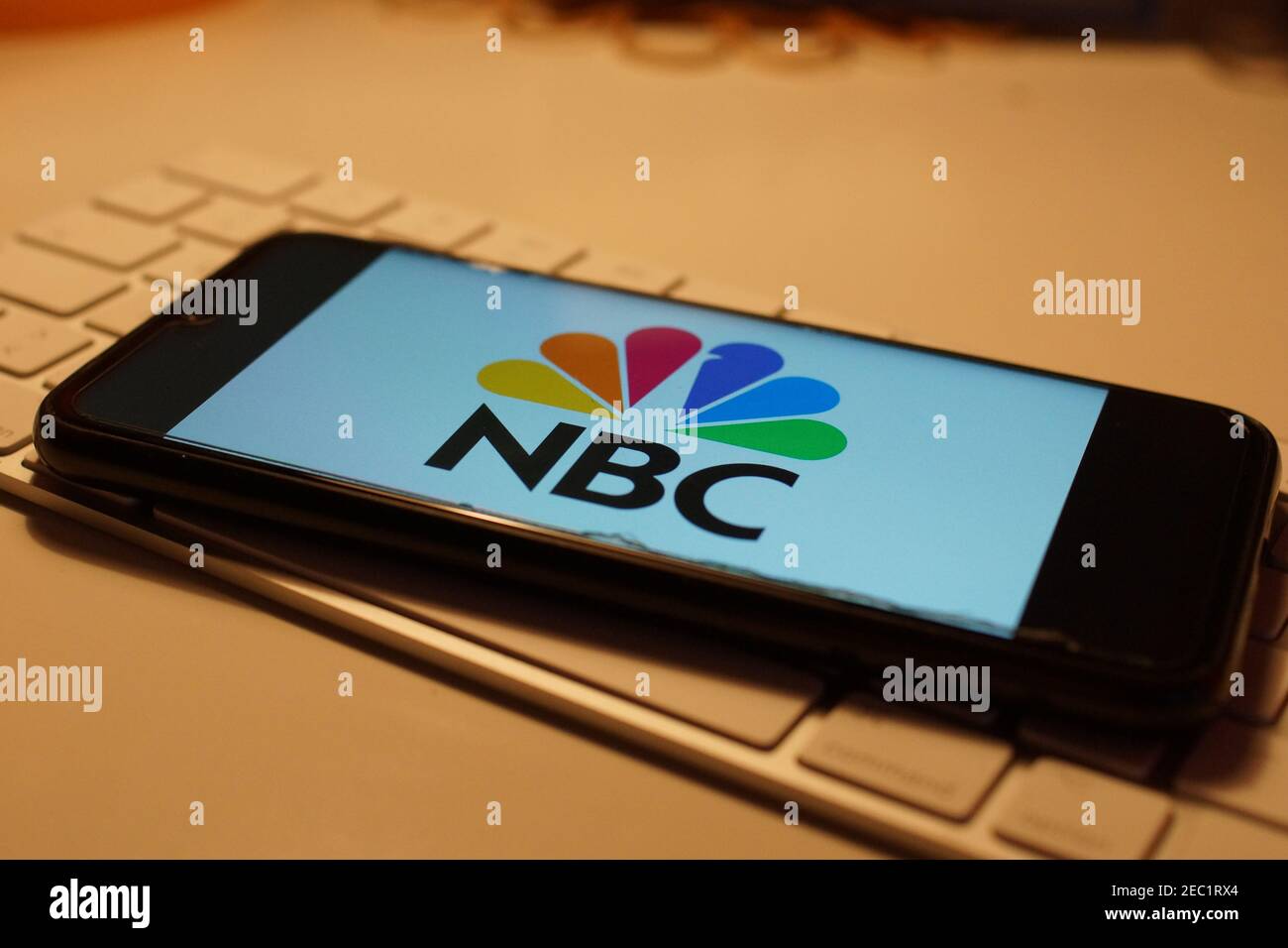Smartphone with NBC logo on computer keyboard Stock Photo