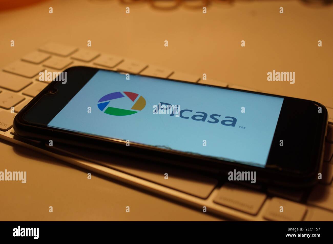 Smartphone with Picasa logo on computer keyboard Stock Photo