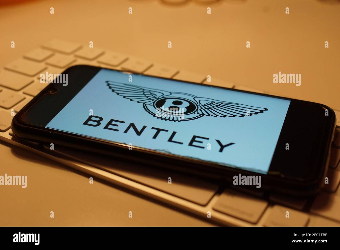 Smartphone with Bentley logo on computer keyboard Stock Photo