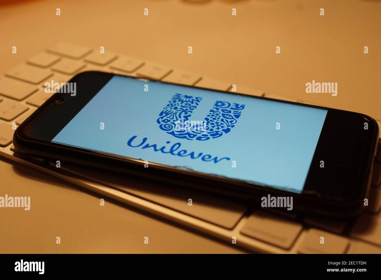 Smartphone with Unilever logo on computer keyboard Stock Photo