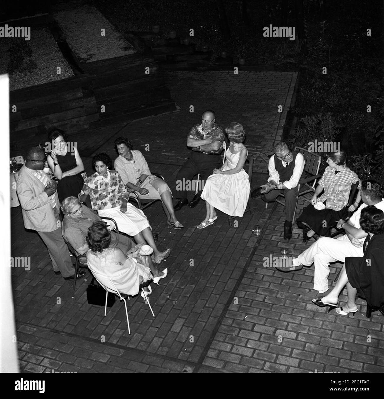 Memorial Day party at Press Secretary Pierre Salingeru0027s home. Memorial Day party at the residence of Press Secretary, Pierre Salinger. Clockwise (from bottom left): unidentified; Helen W. Ganss, of the Press Secretaryu2019s Office; Associate Press Secretary, Andrew T. Hatcher (standing); unidentified woman (standing); three unidentified persons; Faith Hambrook Stoughton; National Park Service (NPS) photographer, Abbie Rowe; Barbara J. Coleman, of the Press Secretaryu2019s Office; White House photographer, Captain Cecil Stoughton; unidentified. Falls Church, Virginia. Stock Photo