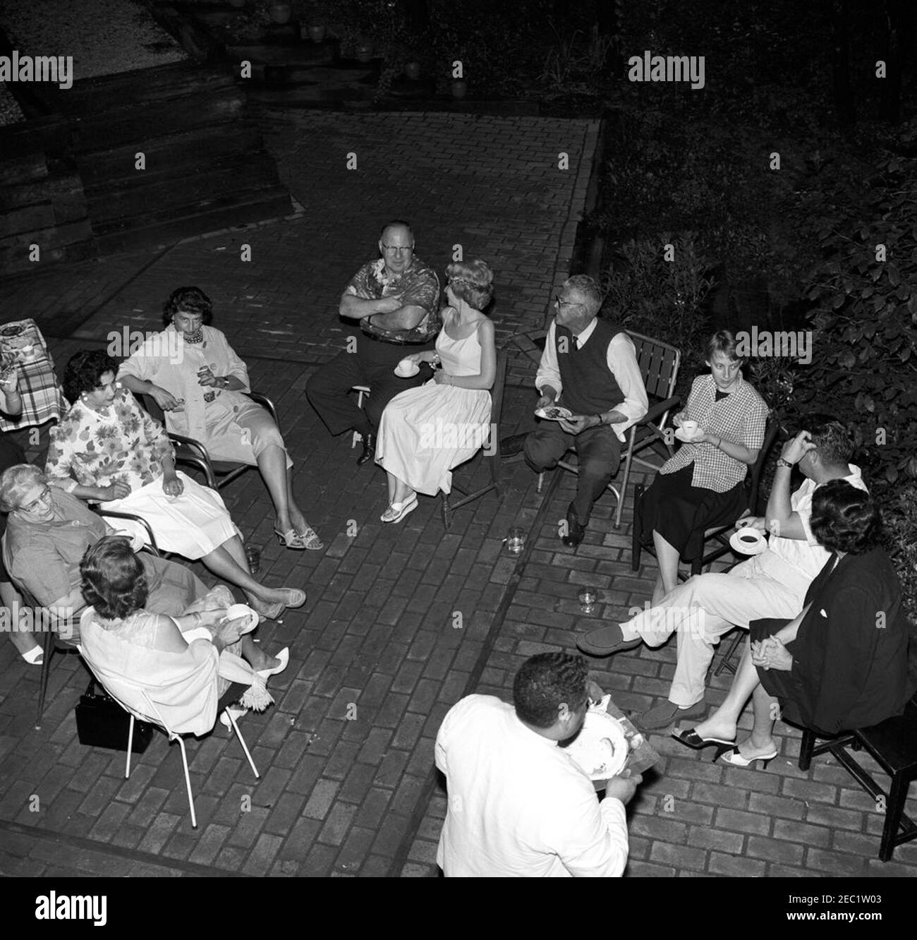 Memorial Day party at Press Secretary Pierre Salingeru0027s home. Memorial Day party at the residence of Press Secretary, Pierre Salinger. Clockwise (from bottom left): unidentified; Helen W. Ganss, of the Press Secretaryu2019s Office; three unidentified persons; Faith Hambrook Stoughton; National Park Service (NPS) photographer, Abbie Rowe; Barbara J. Coleman, of the Press Secretaryu2019s Office; White House photographer, Captain Cecil Stoughton; two unidentified persons. Falls Church, Virginia. Stock Photo