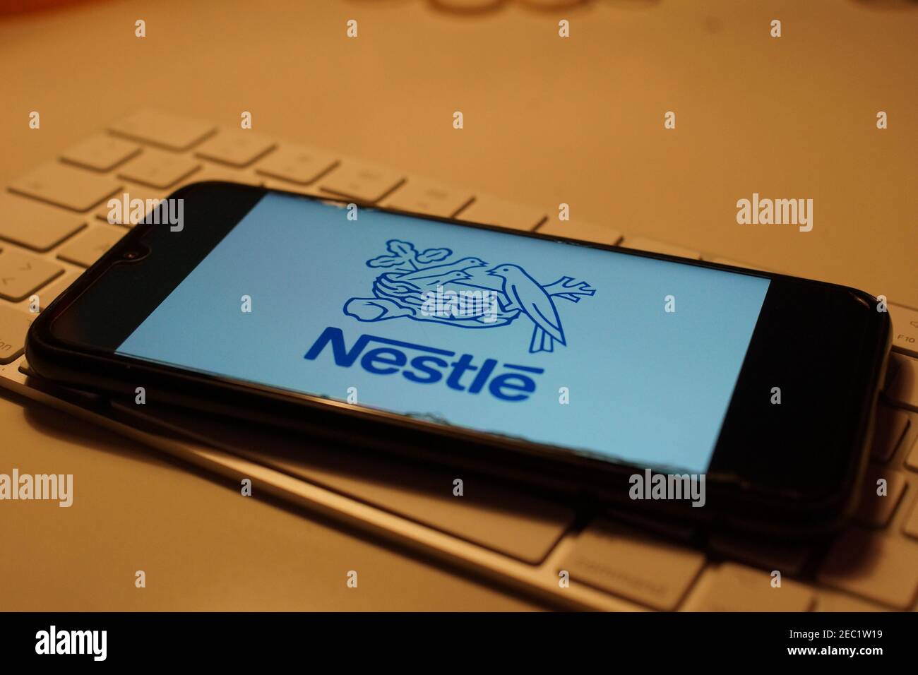 Smartphone with Nestle logo on computer keyboard Stock Photo