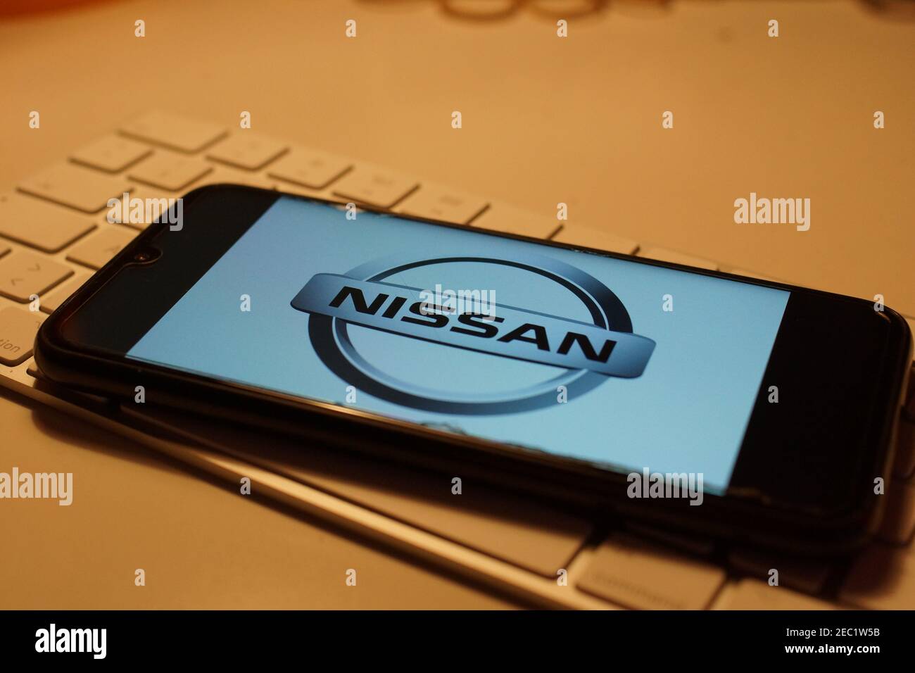 Smartphone with Nissan logo on computer keyboard Stock Photo