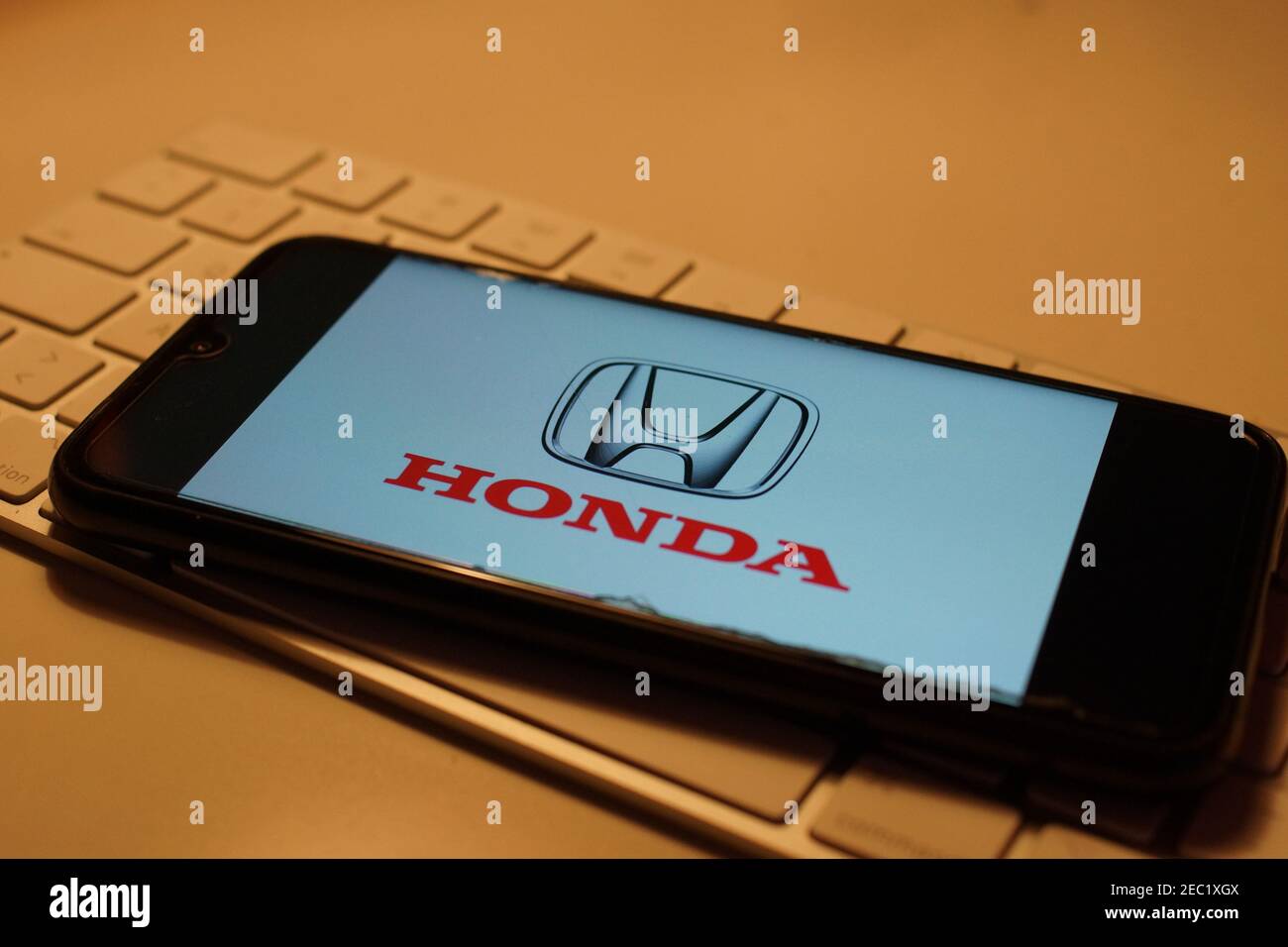 Smartphone with Honda logo on computer keyboard Stock Photo