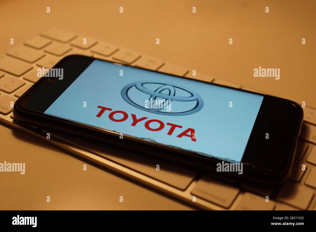 Smartphone with Toyota logo on computer keyboard Stock Photo