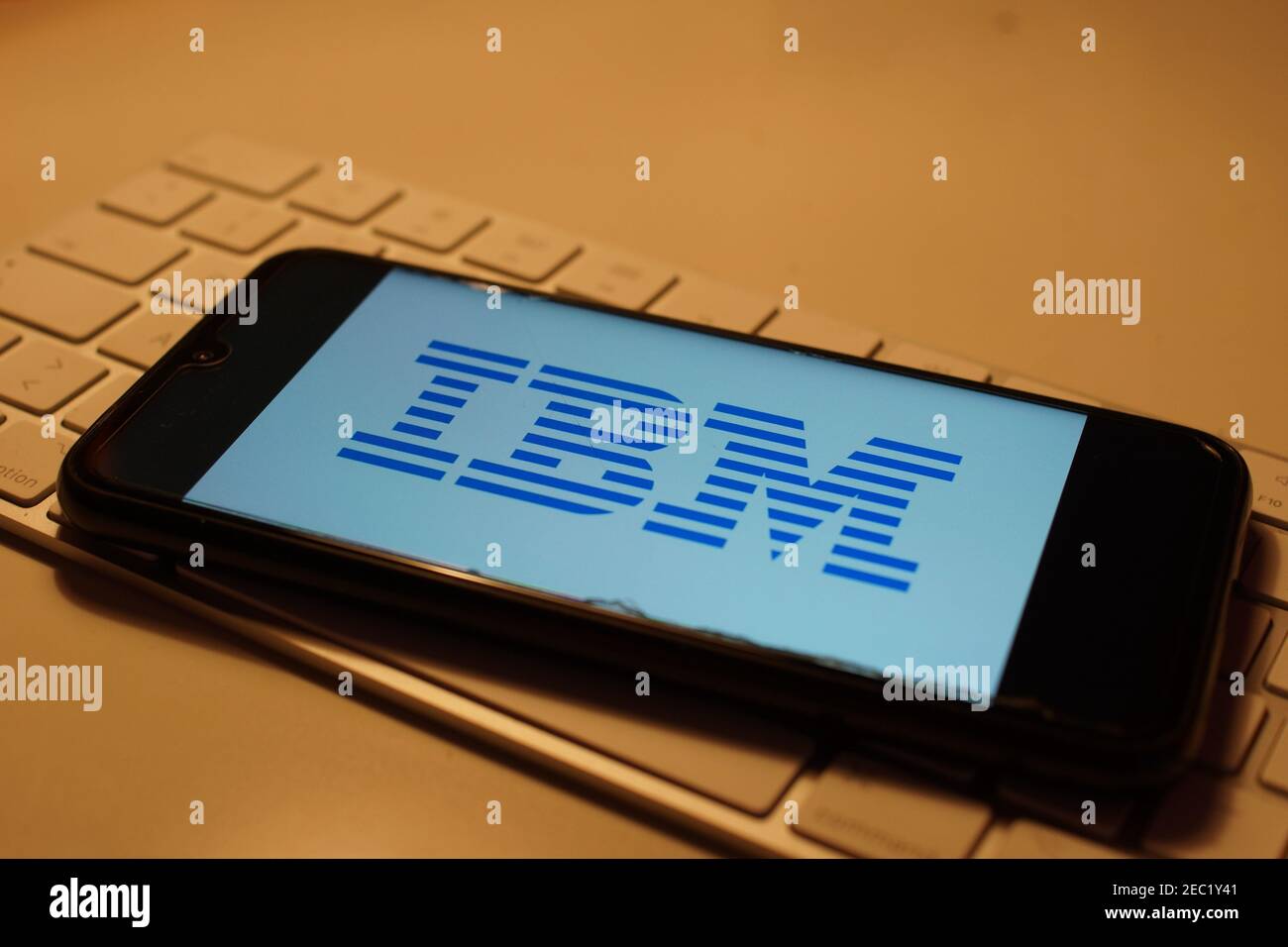Smartphone with IBM logo on computer keyboard Stock Photo