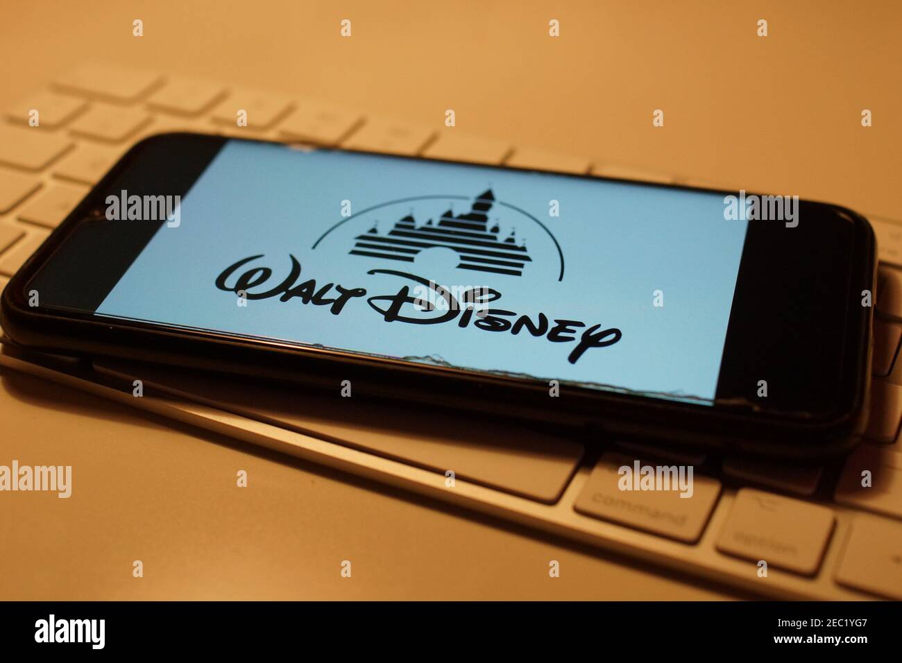 Smartphone with Walt Disney logo on computer keyboard Stock Photo