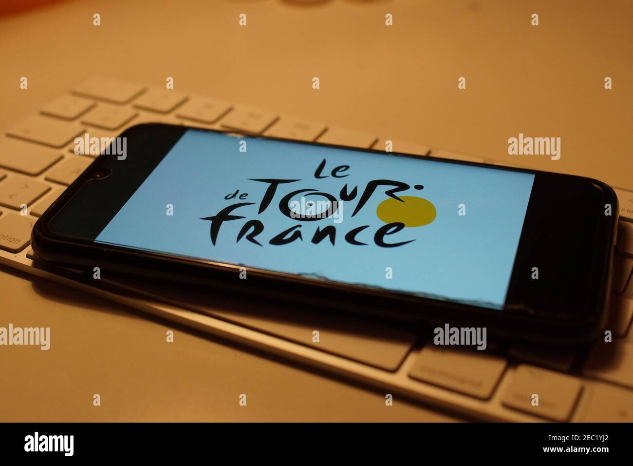 Smartphone with Tour de france logo on computer keyboard Stock Photo