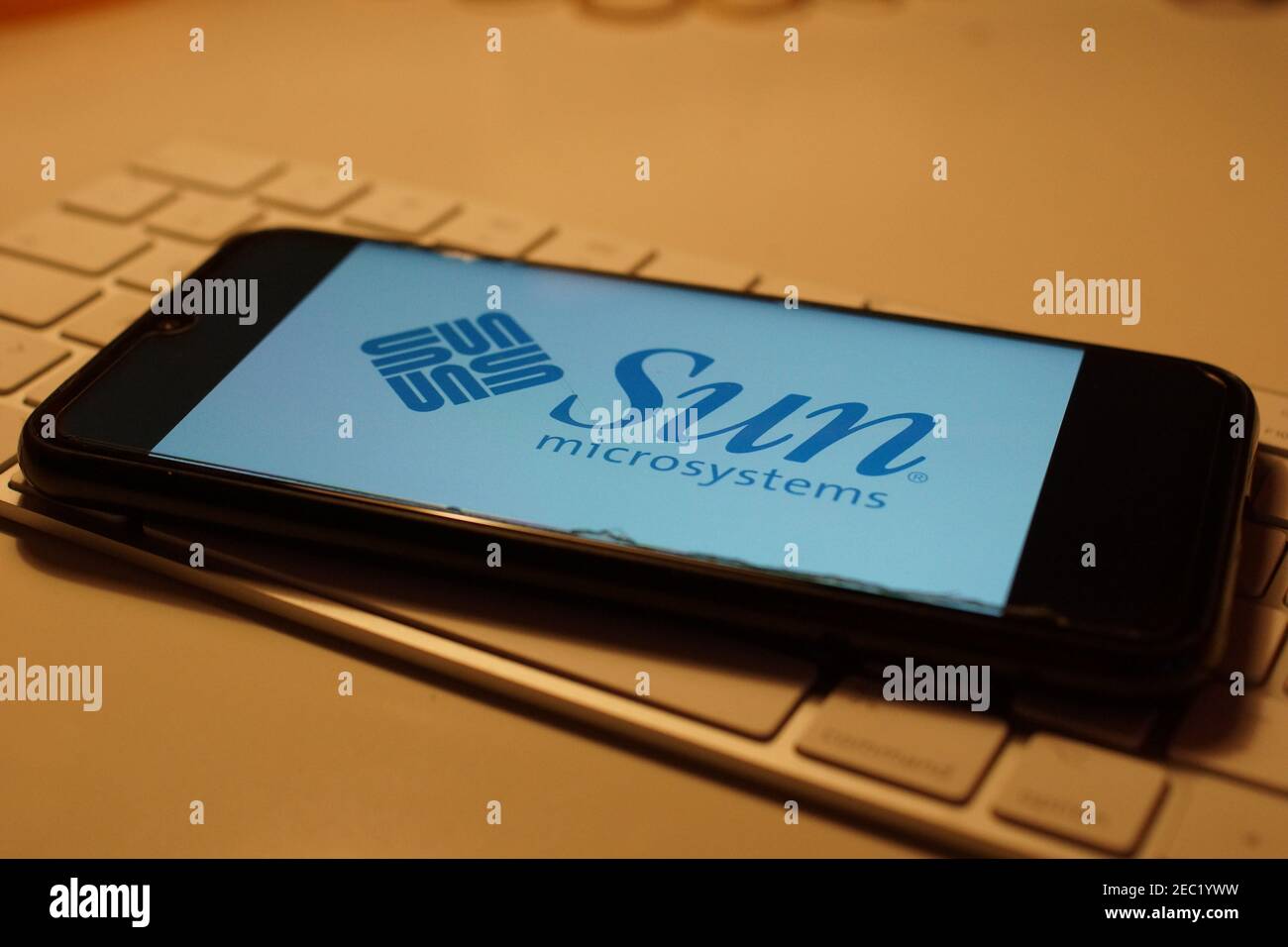 Smartphone with Sun logo on computer keyboard Stock Photo