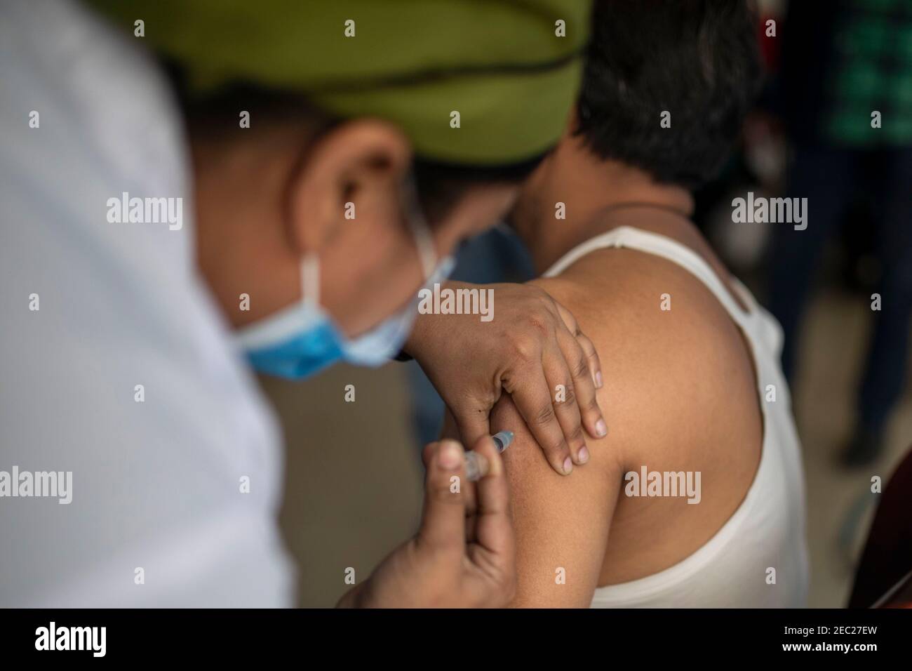 Nurse vaccinating a woman with the Covid 19 vaccine at a hospitan in Dhaka, Bangladesh Stock Photo