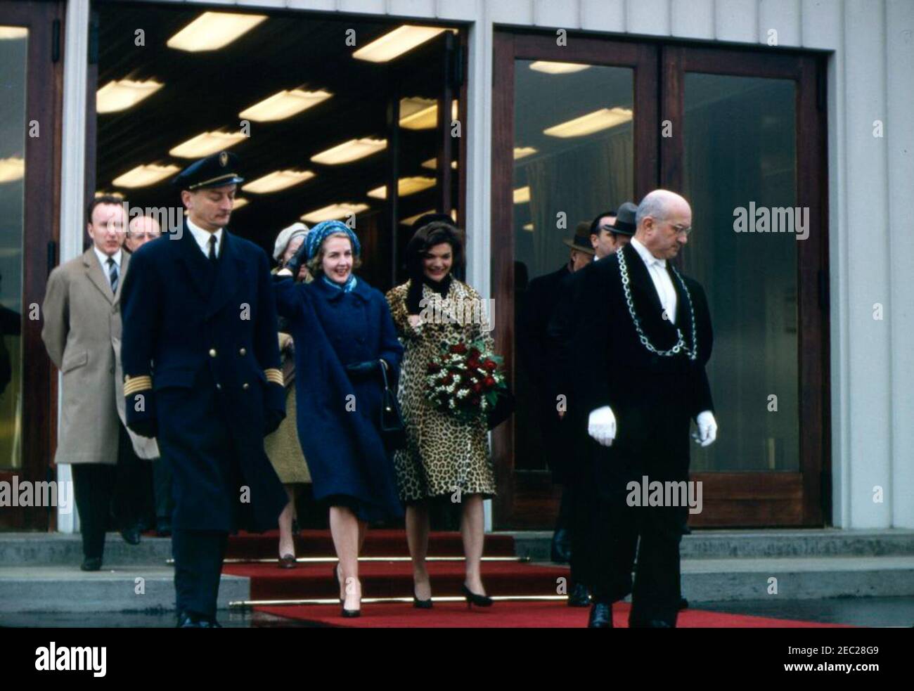 First Lady Jacqueline Kennedyu2019s (JBK) trip to India and Pakistan: Rome, Italy, visit to Pontifical North American College; city views. First Lady Jacqueline Kennedy (center) walks with several unidentified persons, following her arrival in Rome, Italy. Mrs. Kennedy visited Italy and Vatican City, to meet with Pope John XXIII, en route to India and Pakistan. Stock Photo