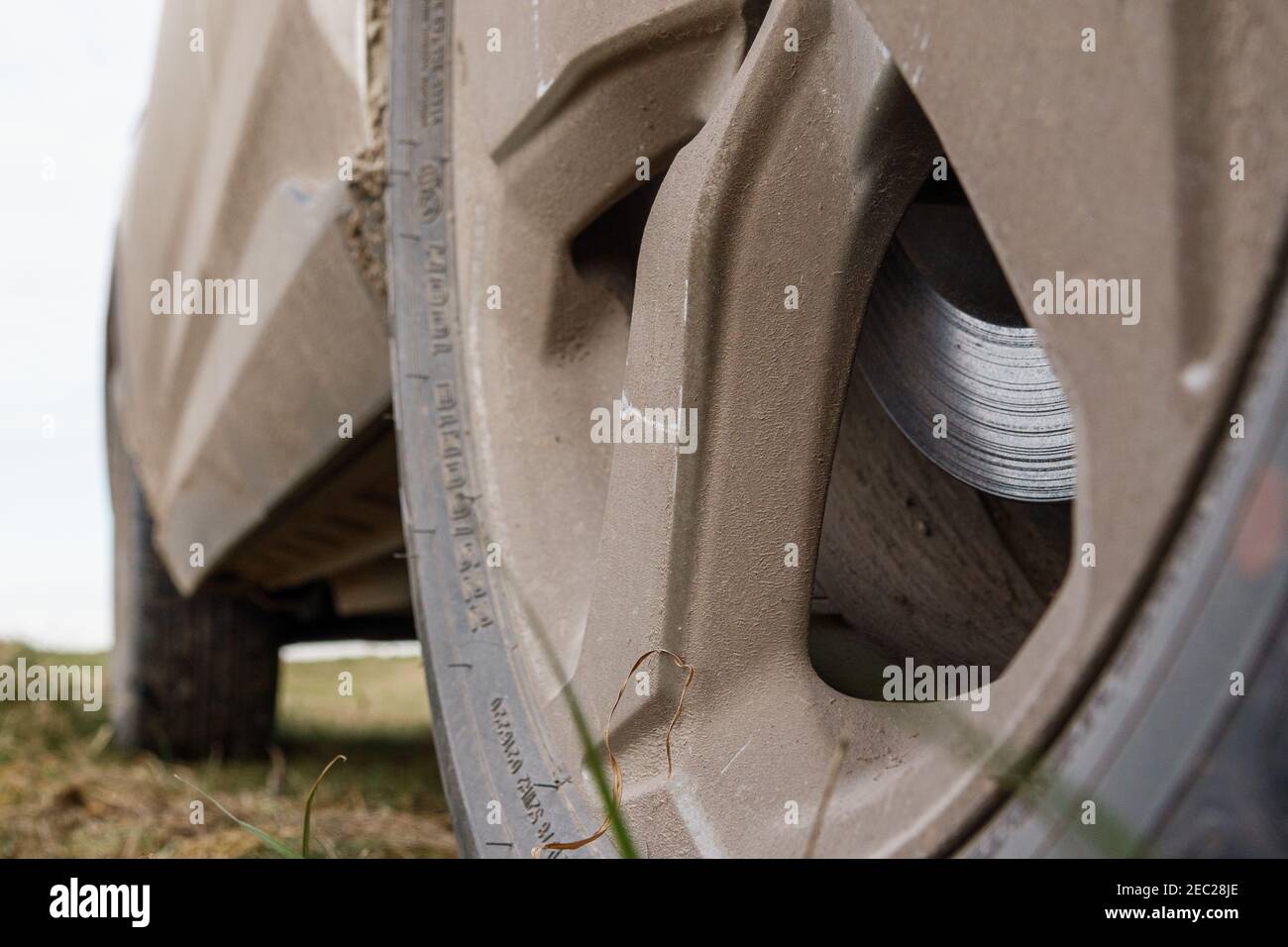 looking at rear wheel and along the sill of a mud covered recreational activity vehicle Toyota RAV4 Stock Photo