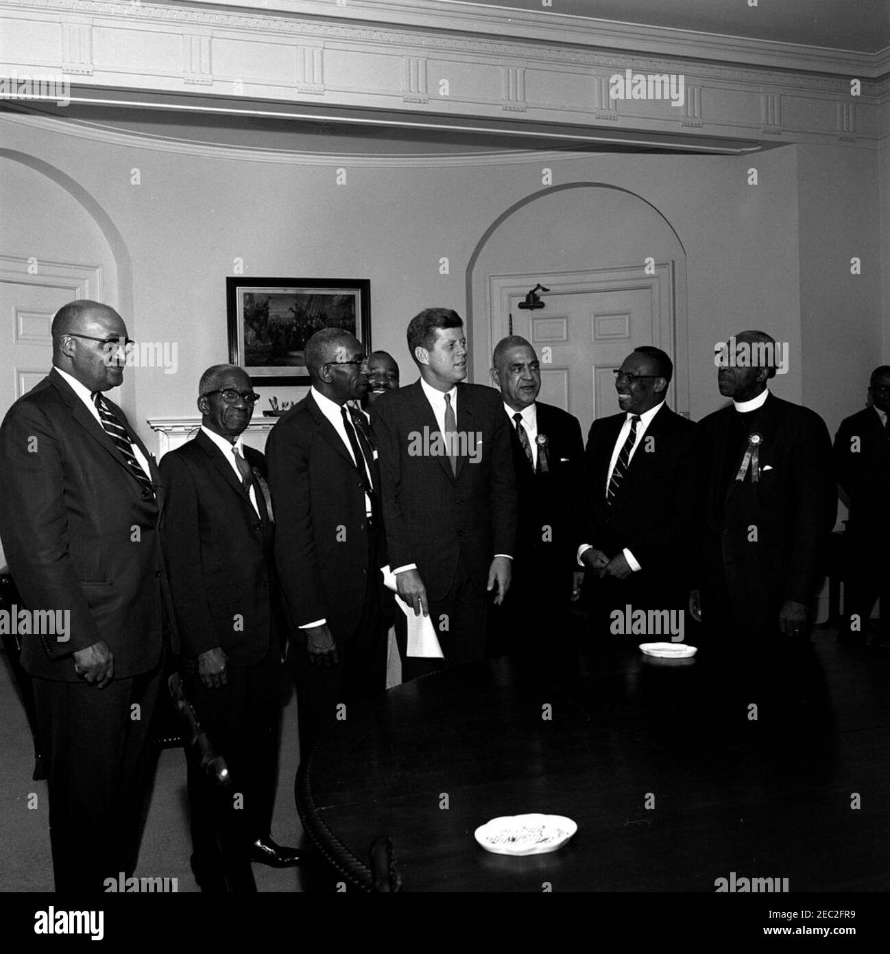 Visit of New England Baptist Missionary Convention delegates, 12:30PM. President John F. Kennedy visits with delegates of the New England Baptist Missionary Convention. Those present include: President of the Convention and Pastor of Wayland Temple Baptist Church in Philadelphia, Pennsylvania, Reverend Dr. Clarence M. Smith; Chairman of the Convention and Associate Pastor of Abyssinian Baptist Church in New York City, Reverend Dr. David N. Licorish; Pastor of Third Baptist Church in Springfield, Massachusetts, Reverend Dr. Paul A. Fullilove; A. A. Lewis; J. Leonard Morgan. Fish Room, White Hou Stock Photo