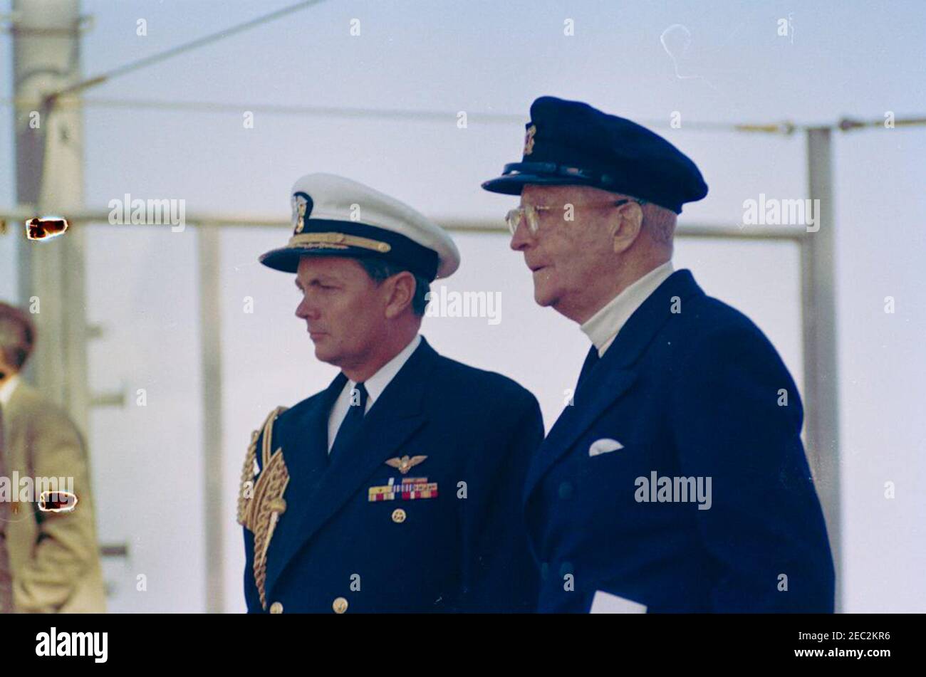 President Kennedy watches the 4th Americau0027s Cup Race. Naval Aide to the President, Captain Tazewell Shepard (left), and Harold S. Vanderbilt attend the fourth race of the 1962 Americau0027s Cup aboard the USS Joseph P. Kennedy, Jr., off the coast of Newport, Rhode Island. [Dark spots on left side of image are original to the negative.] Stock Photo