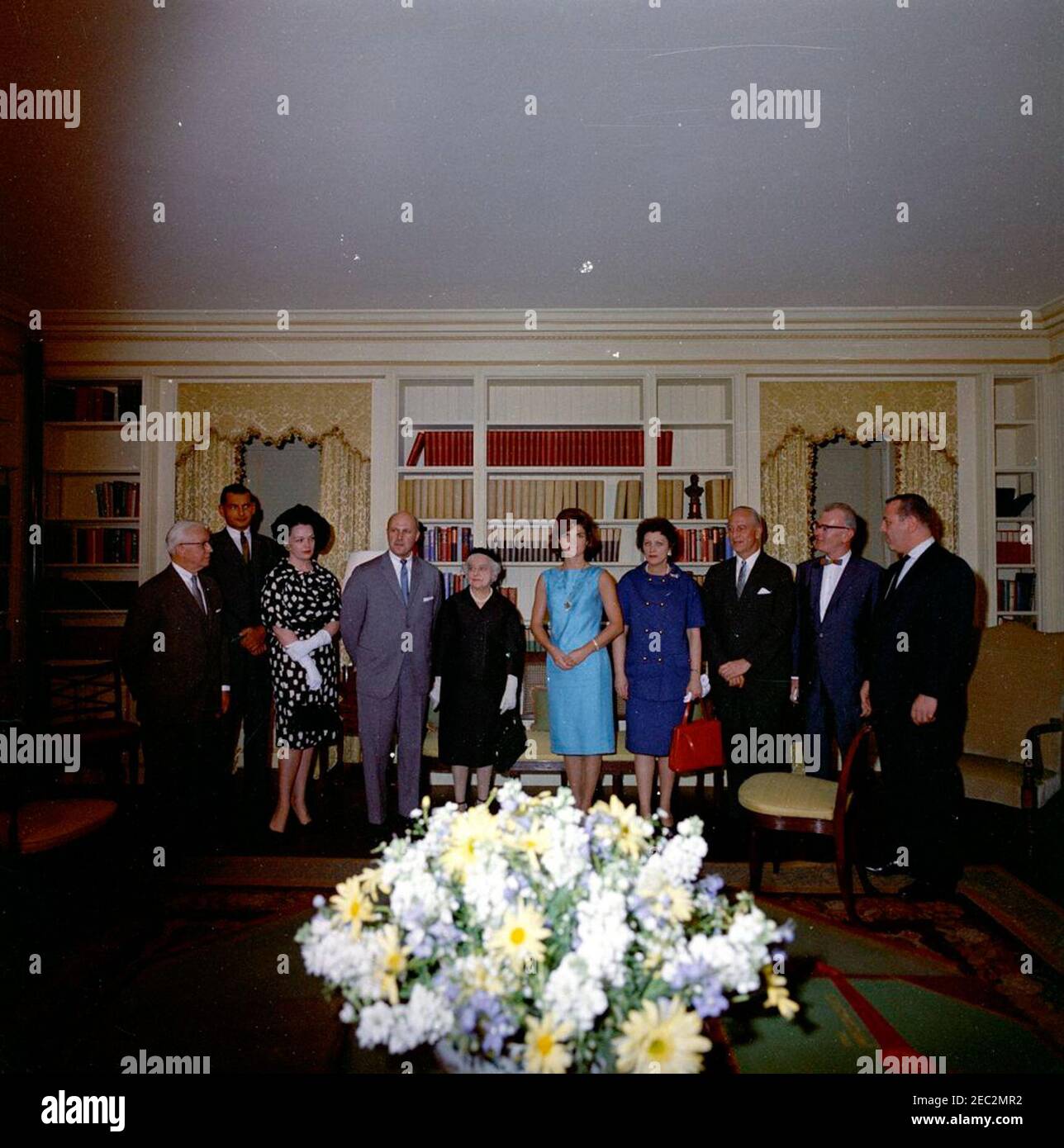 First Lady Jacqueline Kennedy (JBK) opens the refurbished White House Library. First Lady Jacqueline Kennedy poses with officers of the American Institute of Interior Designers (AID) at the opening of the refurbished White House Library; the restoration of the Library was a gift from the AID. Left to right: Stephen J. Jussel; two unidentified persons; President of the AID, Milton Glaser; chairman of the Library designersu2019 committee, Jeannette Becker Lenygon; Mrs. Kennedy; Ellen Lehman McCluskey; past President of the AID, J. H. Leroy Chambers; two unidentified men. Washington, D.C. Stock Photo