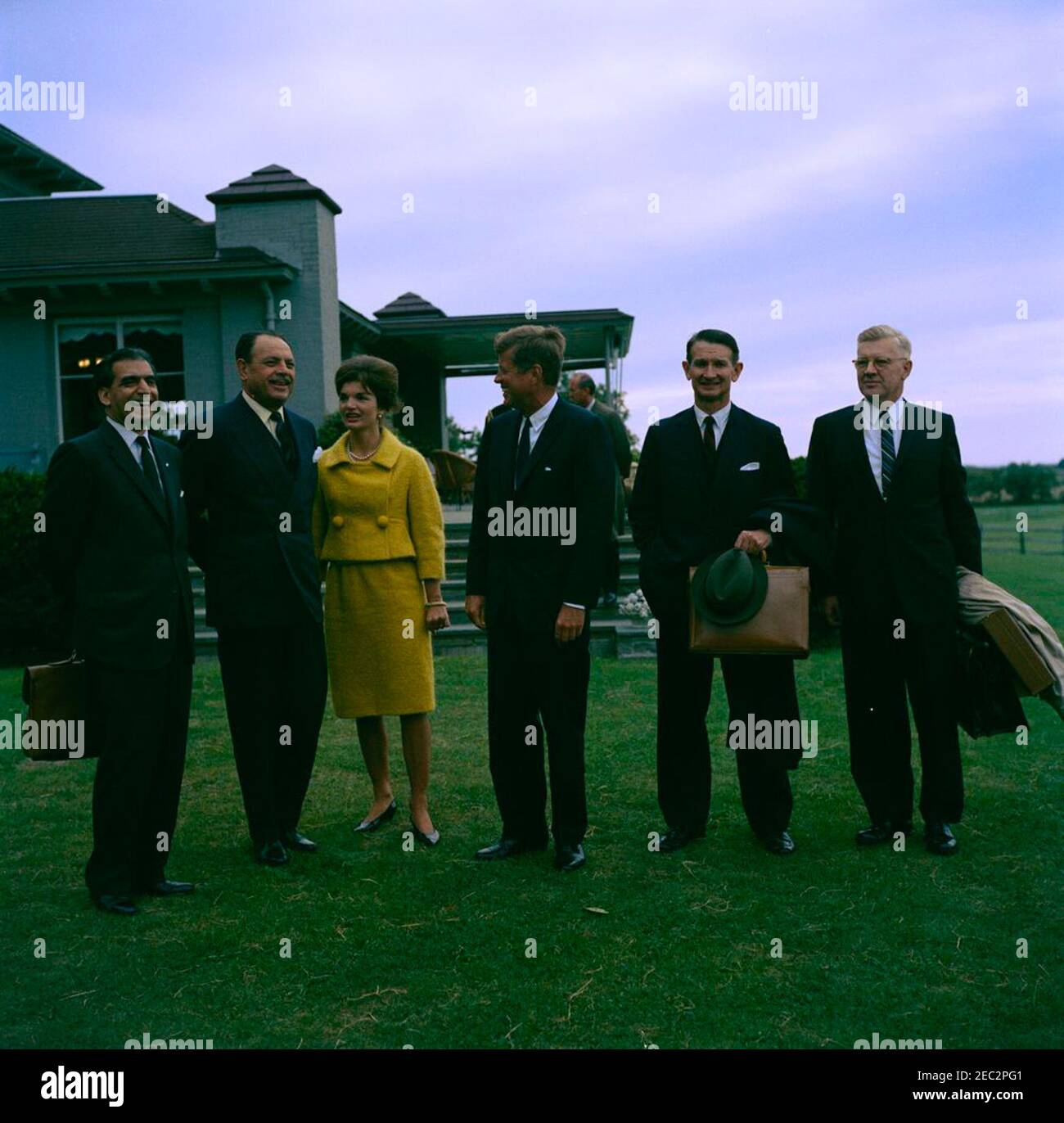 Visit of Muhammad Ayub Khan, President of Pakistan, Newport, Rhode Island. President John F. Kennedy and First Lady Jacqueline Kennedy visit with President of Pakistan, Muhammad Ayub Khan, at Hammersmith Farm in Newport, Rhode Island. Left to right (in foreground): Ambassador of Pakistan, Aziz Ahmed; President Ayub Khan; Mrs. Kennedy; President Kennedy; U.S. Ambassador to Pakistan, Walter P. McConaughy; U.S. Assistant Secretary of State for Near Eastern and South Asian Affairs, Phillips Talbot. U.S. Chief of Protocol, Angier Biddle Duke (partially hidden), stands in background. Stock Photo