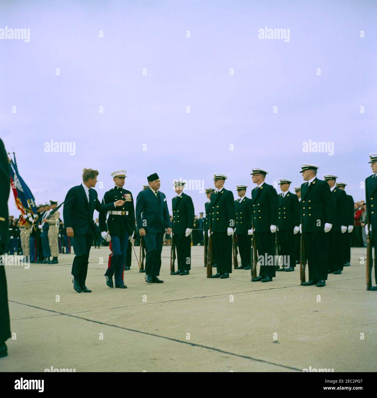 Visit of Muhammad Ayub Khan, President of Pakistan, Newport, Rhode Island. President John F. Kennedy and President Muhammad Ayub Khan of Pakistan (center left) review honor guard troops, following President Ayub Khanu0027s arrival at Quonset Point Naval Air Station; Major Arthur J. Poillon, United States Marine Corps (USMC), escorts the Presidents. North Kingstown, Rhode Island. Stock Photo