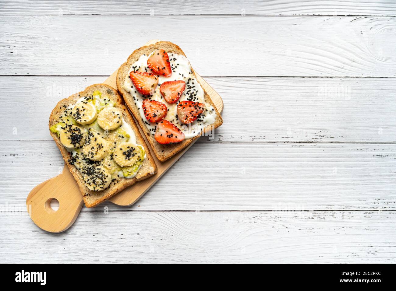 Healthy breakfast toasts with banana, sesame, strawberry, Yoghurt on