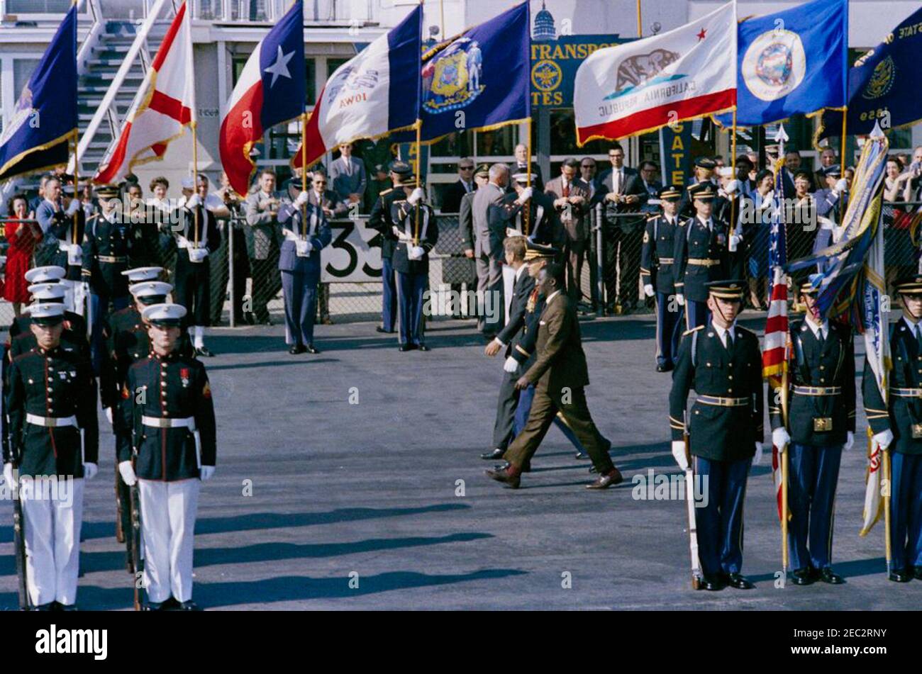 Arrival ceremony for Ahmed Su00e9kou Touru00e9, President of Guinea, 11:00AM. President John F. Kennedy and President of Guinea, Ahmed Su00e9kou Touru00e9, review honor guard troops during arrival ceremonies for President Touru00e9; an unidentified Commander of Troops walks with the Presidents. Military Air Transport Service (MATS) terminal, Washington National Airport, Washington D.C. Stock Photo