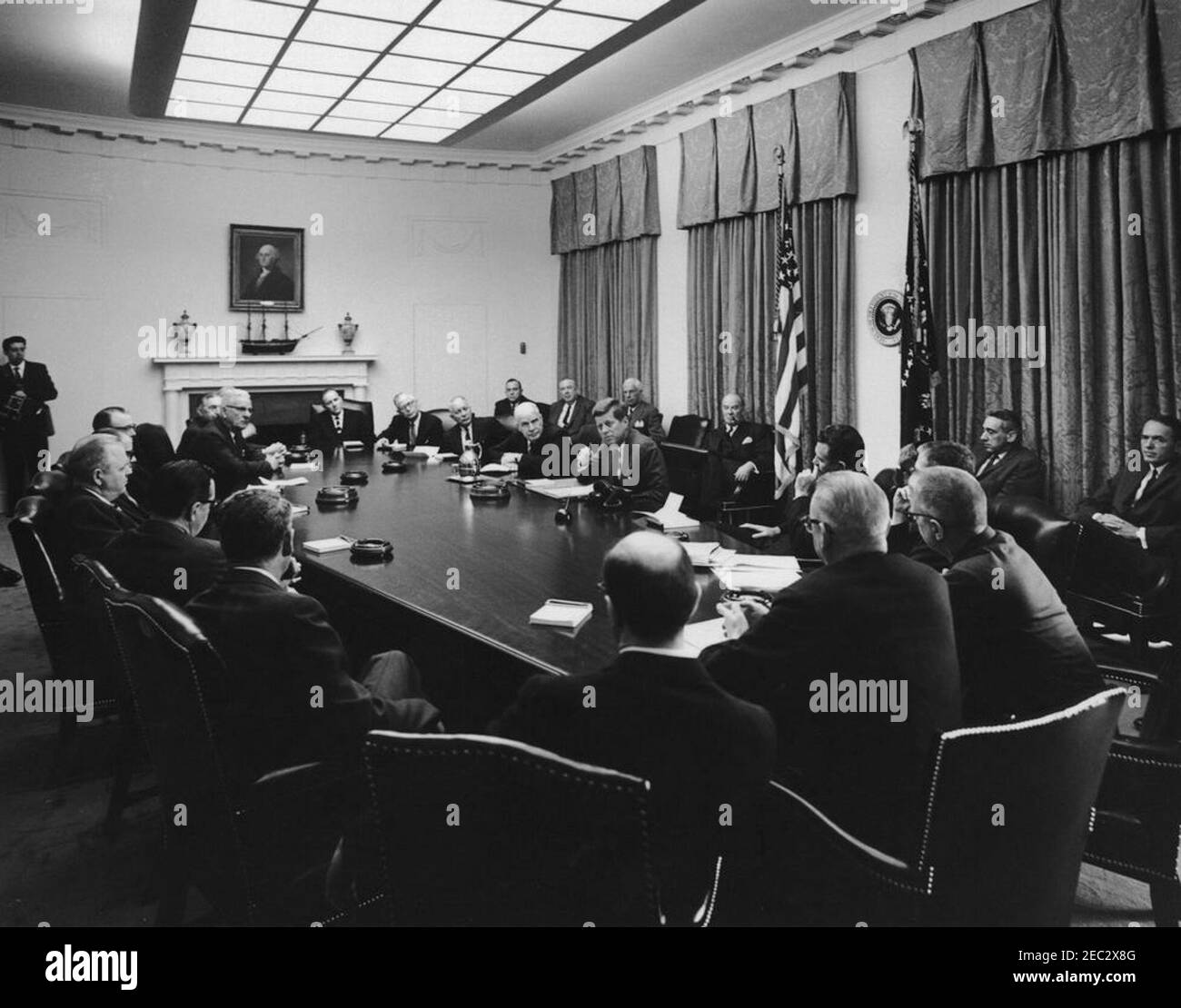 Visit of members of the National Export Expansion Council in the Cabinet Room, 12:10PM. President John F. Kennedy (center, seated at right side of table) talks with members of the National Export Expansion Council in the Cabinet Room of the White House, Washington, D.C. Secretary of Commerce Luther H. Hodges sits left of President Kennedy; Roger P. Sonnabend, Executive Vice President of Hotel Corporation of America (three seats left of Secretary Hodges), sits at the head of the table; all others are unidentified. [Please see the Presidentu2019s schedule for a complete list of attendees.] Stock Photo