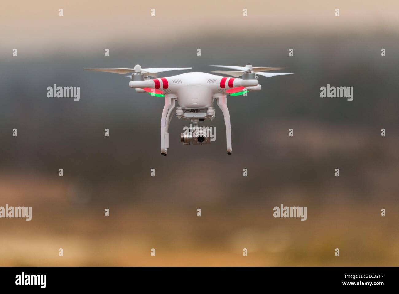 White drone take off from land and flying for taking aerial photo at ...