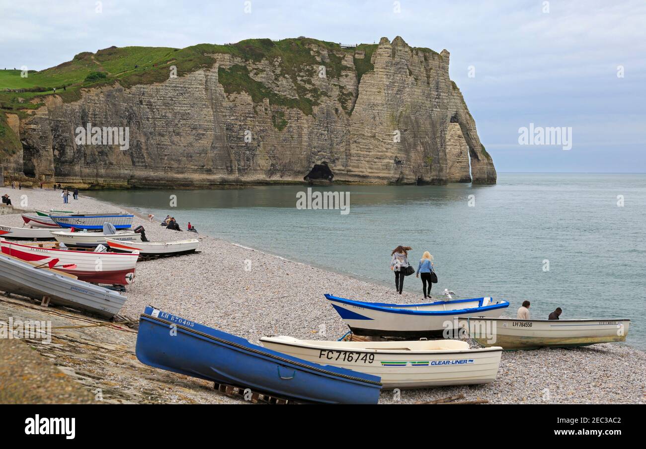 Etretat beach and cliffs, Normandy, France. Fishing dinghies drawn up ...