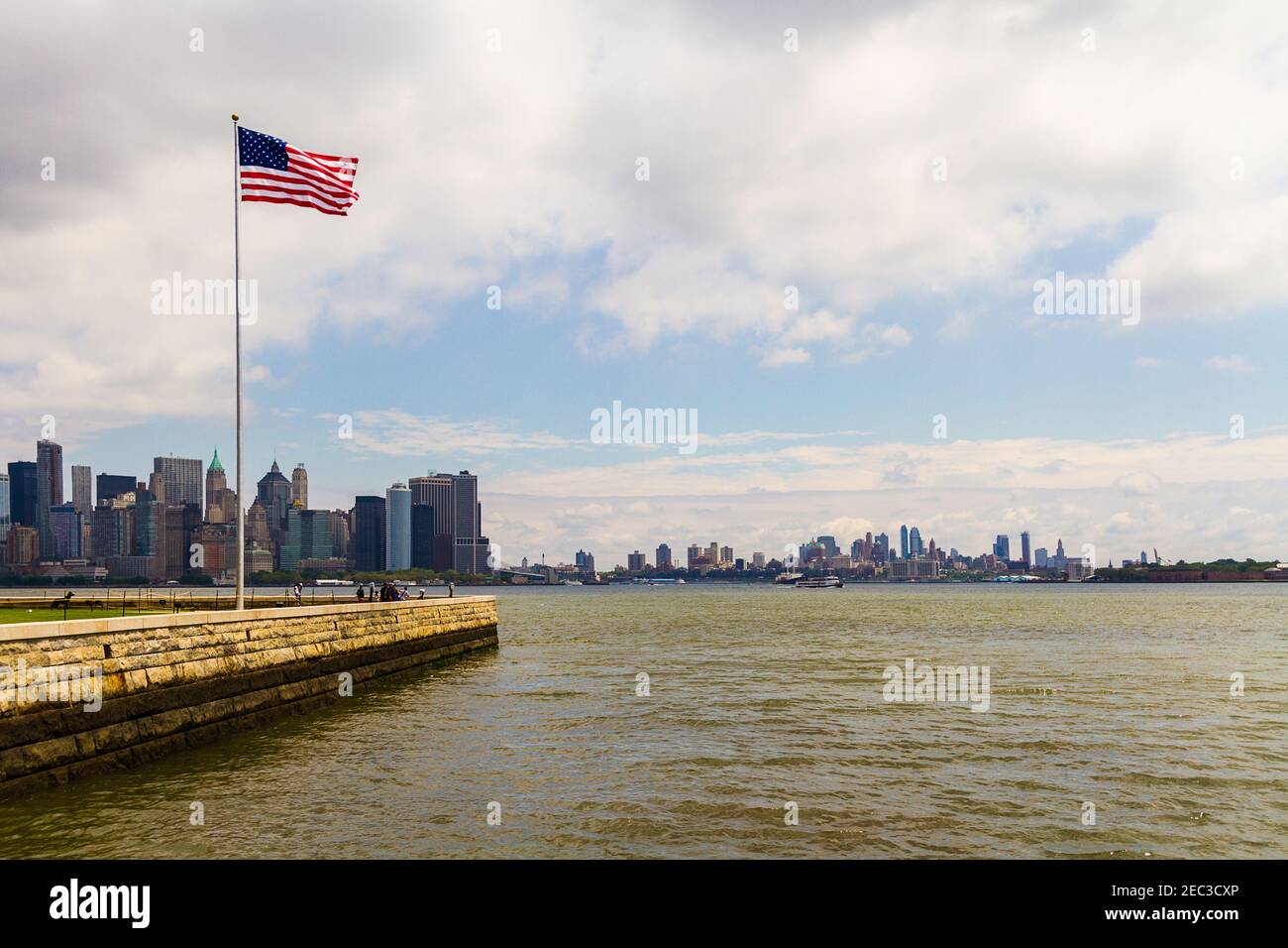 An American flag and Manhattan cityscape in the background Stock Photo