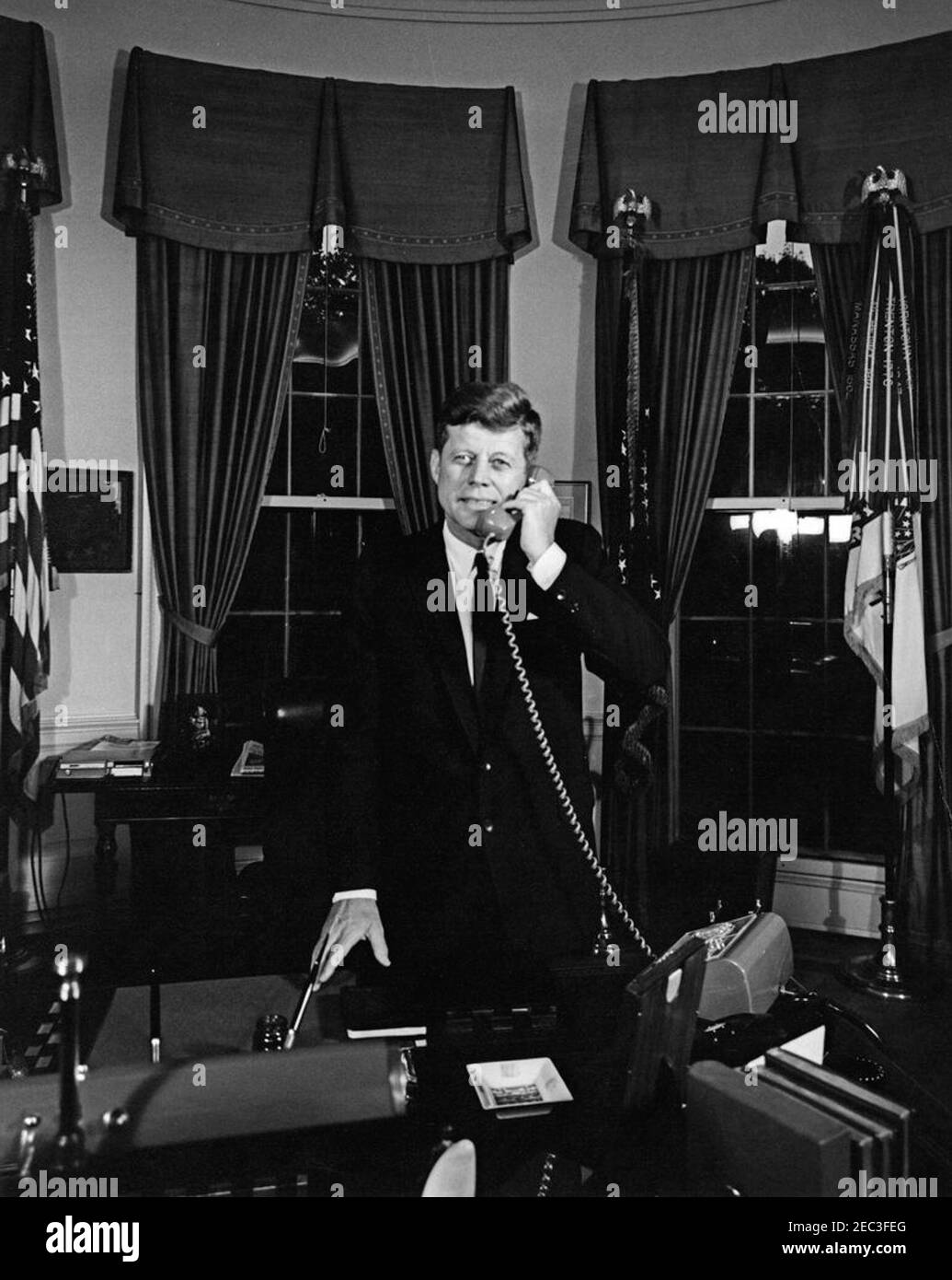 President Kennedy telephones Astronaut Gordon Cooper aboard USS Kearsarge (CVS-33), after recovery of u0022Faith 7u0022. President John F. Kennedy (standing at his desk) speaks on the telephone with astronaut, Major L. Gordon Cooper, following the successful completion of Major Cooperu0027s Mercury-Atlas 9 orbital flight, as part of the final manned space mission of the National Aeronautics and Space Administrationu0027s (NASA) Project Mercury program. Major Cooper was aboard the USS Kearsarge (CVS-33) after splashdown and recovery of the Mercury capsule (also known as Faith 7) in the Paci Stock Photo
