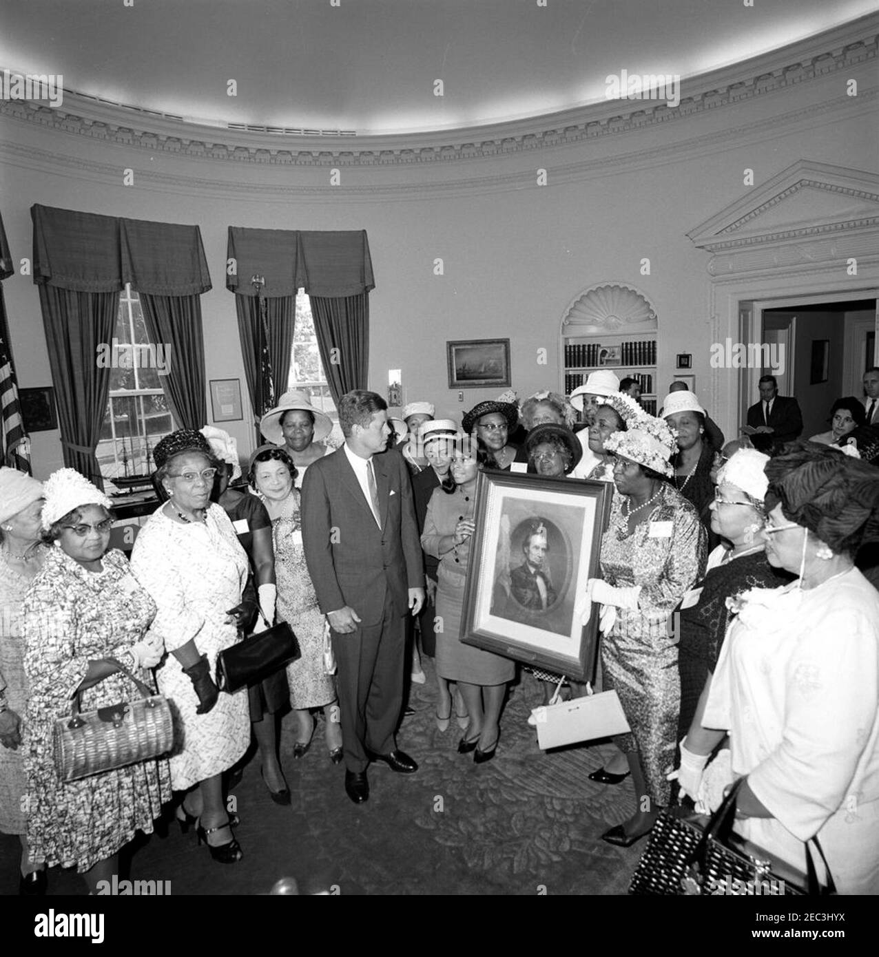 Visit of members of the National Association of Colored Womenu0027s Clubs (NACWC), 3:58PM. President John F. Kennedy visits with members of the National Association of Colored Womenu0027s Clubs (NACWC) in the Oval Office; the visitors presented President Kennedy with a portrait of Abraham Lincoln. Members present include: National President of the NACWC, Dr. Rosa Gragg; Lucinda E. Bryant of Yakima, Washington; Fannye J. Benford of Gary, Indiana; Jean Murrell Capers of Cleveland, Ohio; Melnea Cass of Roxbury, Massachusetts; Jessie Mae David; Mabel E. Diggs of Boston, Massachusetts; Georgia Du Stock Photo