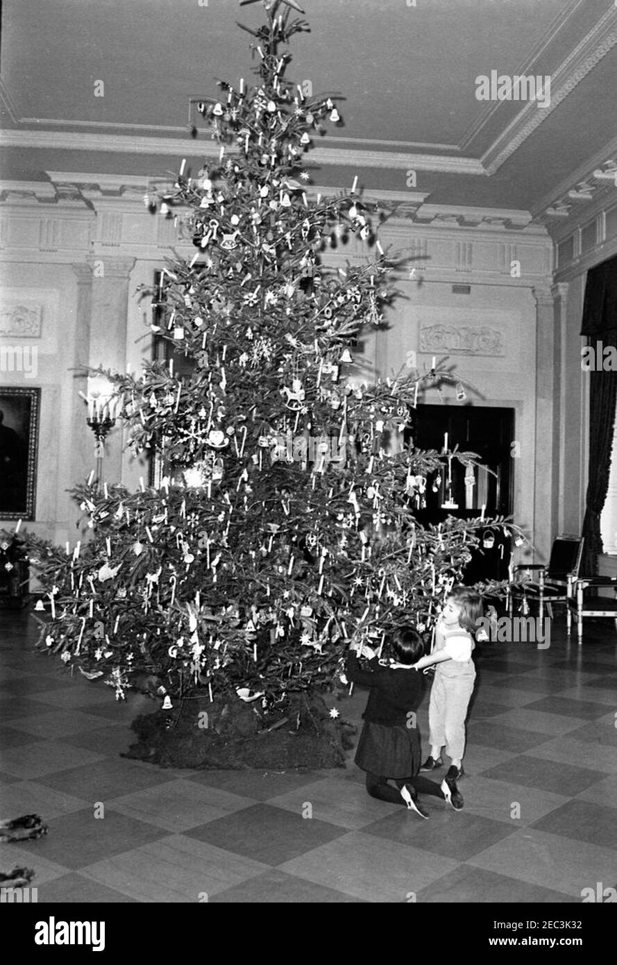 Caroline Kennedy (CBK) with a friend. Caroline Kennedy (right) and an unidentified friend (kneeling) put candy canes on the lower branches of the Christmas tree in the North Entrance Hall of the White House, Washington, D.C. Stock Photo