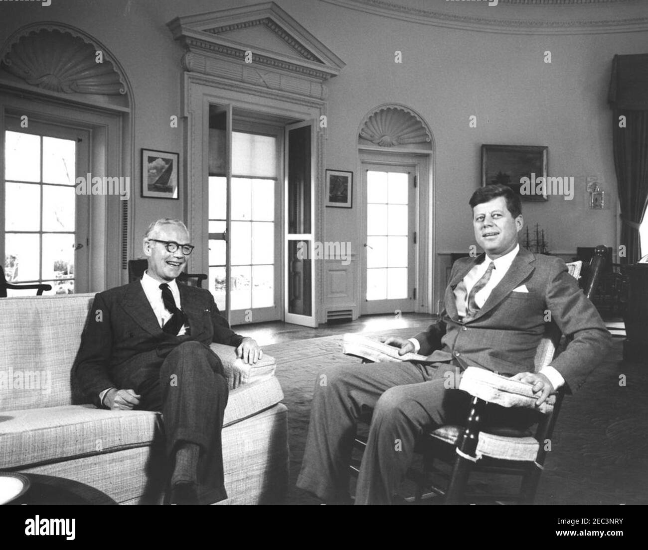 Meeting with the Ambassador of Canada, Arnold D. P. Heeney, 11:00AM. President John F. Kennedy (in rocking chair) meets with the Ambassador of Canada, Arnold (A.D.P.) Heeney in the Oval Office of the White House, Washington, D.C. Stock Photo