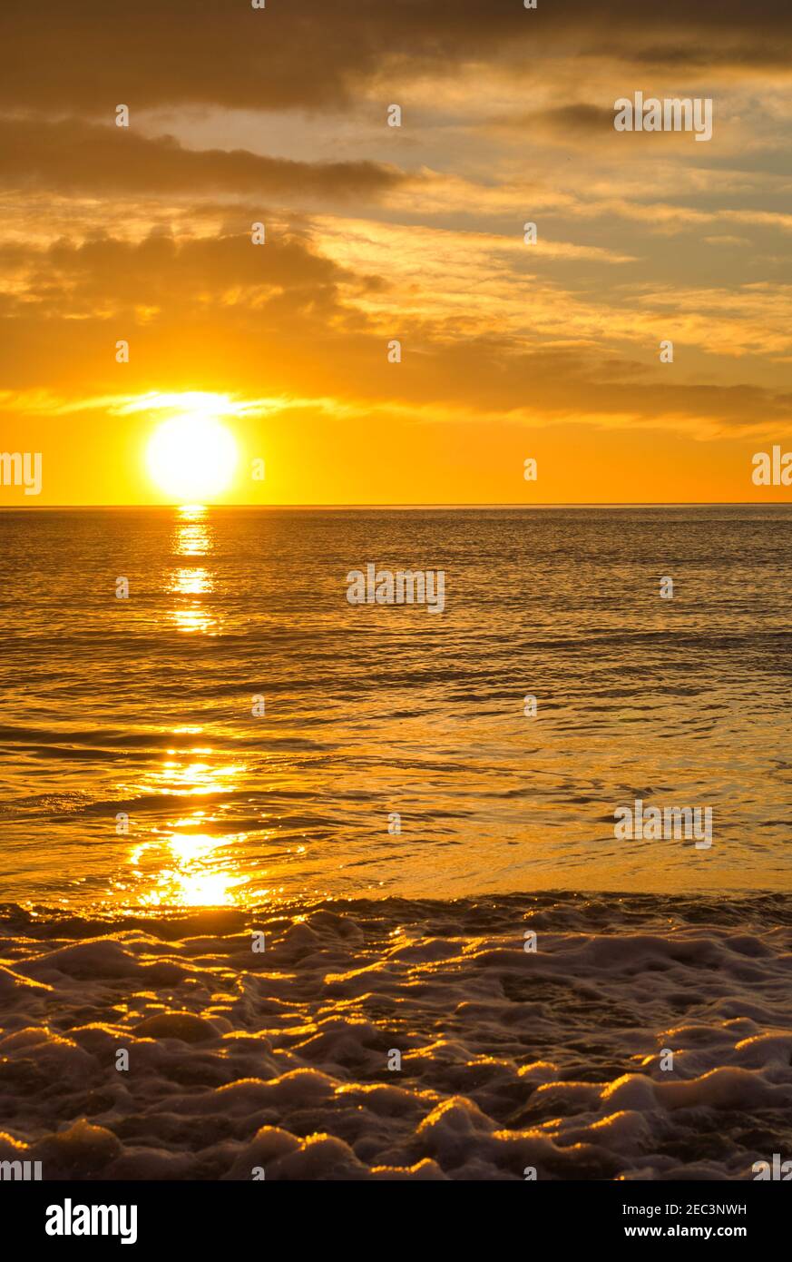 A nice and calm sunrise from the shore of the beach Stock Photo
