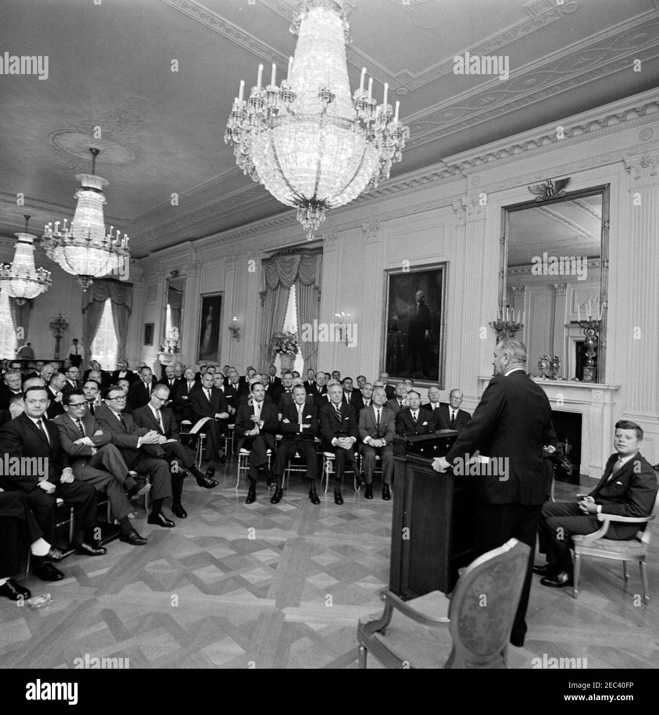 Meeting with businessmen to discuss civil rights, 5:22PM. Vice President Lyndon B. Johnson (at lectern, with back to camera) speaks to a group of business executives with establishments in southern cities, at a civil rights meeting conducted by President John F. Kennedy (seated at far right), Vice President Johnson, and Attorney General Robert F. Kennedy (not pictured). Those pictured include: Milton L. Elsberg, President of Drug Fair Inc.; Carling L. Dinkler, Jr., President of Dinkler Hotel Corporation; Lucien E. Oliver, Vice President of Sears, Roebuck u0026 Company; Louis C. Lustenberger, Stock Photo