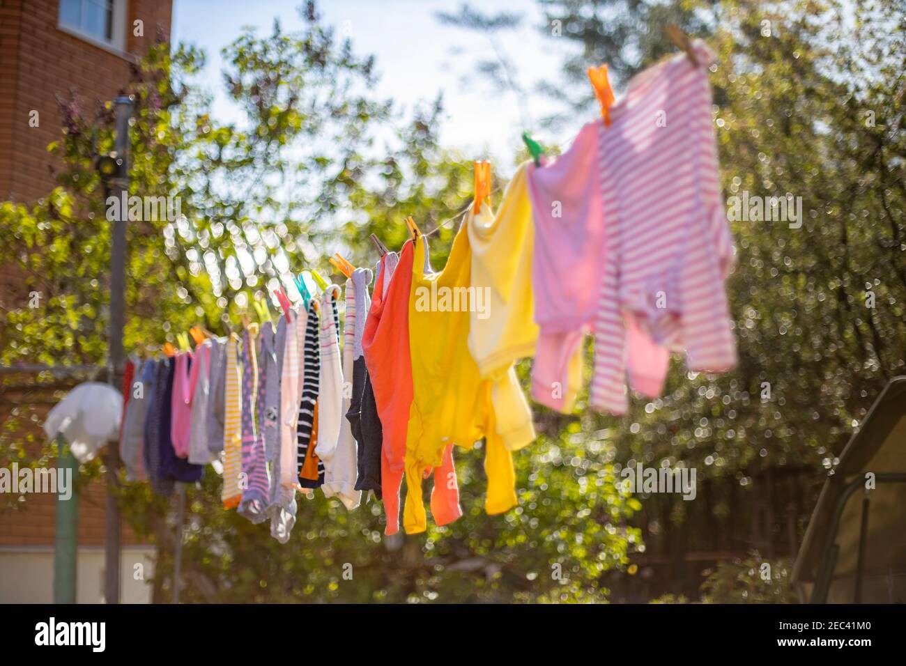 Baby cute clothes hanging on the clothesline outdoor. Child