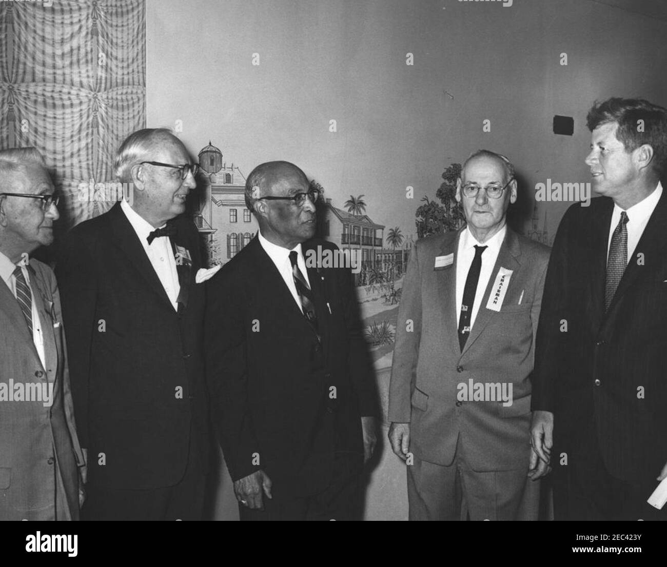 Address to the National Convention of the National Council of Senior Citizens, 11:47AM. President John F. Kennedy visits with attendees of the National Convention of the National Council of Senior Citizens at the Willard Hotel, Washington D.C. (L-R): unidentified; Council Vice President, Burt Garnett; Director of Special Projects for the Council, Lawrence A. Oxley; Council Chairman, John Fitzpatrick; President Kennedy. Stock Photo