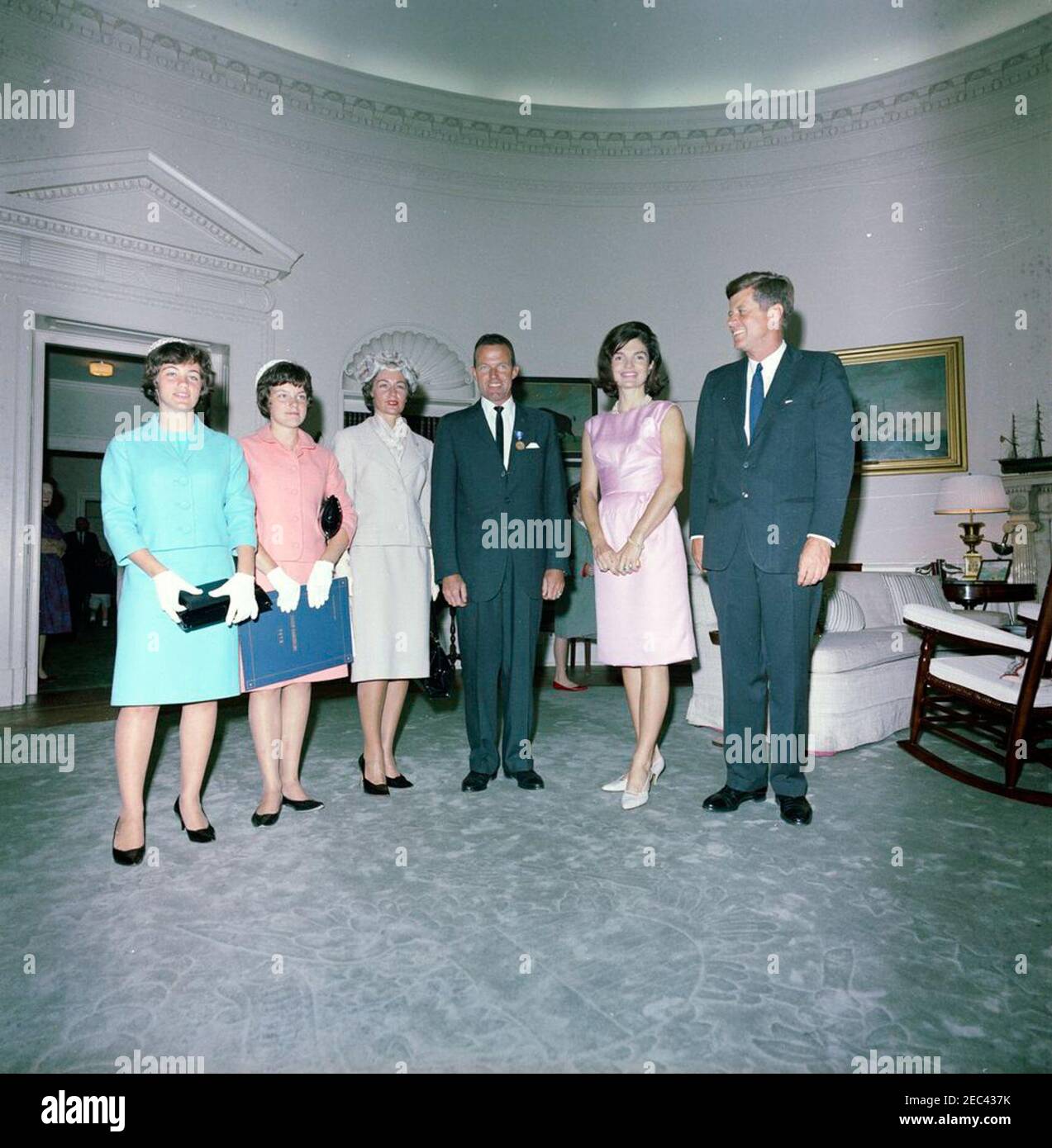 Presentation of the National Aeronautics and Space Administration (NASA) Distinguished Service Medal (DSM) to Astronaut Major L. Gordon Cooper, 12:15PM. President John F. Kennedy and First Lady Jacqueline Kennedy visit with astronaut Major L. Gordon Cooper and his family, following Major Cooperu2019s National Aeronautics and Space Administration (NASA) Distinguished Service Medal (DSM) presentation ceremony. Left to right: Major Cooperu2019s daughters, Camala and Janita; his wife, Trudy; Major Cooper; Mrs. Kennedy; President Kennedy. Oval Office, White House, Washington, D.C. Stock Photo