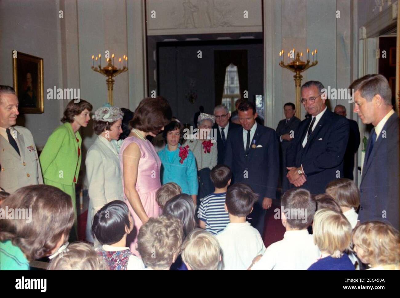 Presentation of the National Aeronautics and Space Administration (NASA) Distinguished Service Medal (DSM) to Astronaut Major L. Gordon Cooper, 12:15PM. Astronaut Major L. Gordon Cooper speaks with a group of children, following his National Aeronautics and Space Administration (NASA) Distinguished Service Medal (DSM) presentation ceremony. Left to right: Military Aide to the President, General Chester V. Clifton; Eunice Kennedy Shriver; Trudy Cooper, wife of Major Cooper; First Lady Jacqueline Kennedy; Camala Cooper, Jewell D. Truscott, and James J. Truscott, Major Cooperu2019s daughter, aun Stock Photo