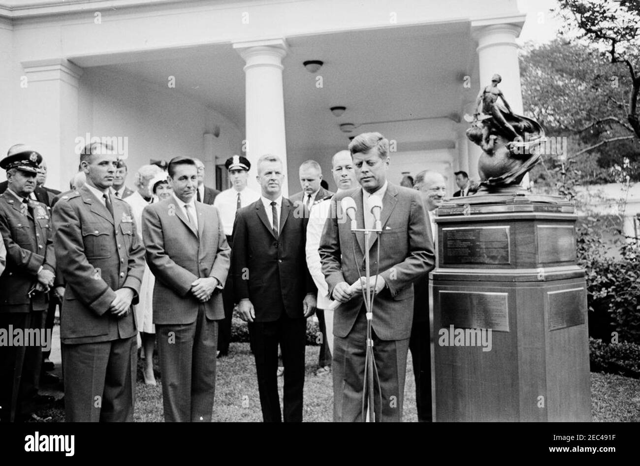 Presentation of the 1961 Collier Trophy, 11:30AM. President John F. Kennedy presents the 1961 Robert J. Collier Trophy to four X-15 pilots, on behalf of the National Aeronautic Association (NAA). Standing behind President Kennedy are the recipients (L-R): Major Robert M. White (U.S. Air Force), A. Scott Crossfield (North American Aviation), Joseph A. Walker (National Aeronautics and Space Administration), and Commander Forrest S. Petersen (U.S. Navy). Also pictured: Chief of Staff of the United States Air Force, General Curtis E. LeMay; General Omar Bradley; White House Secret Service agents, Stock Photo