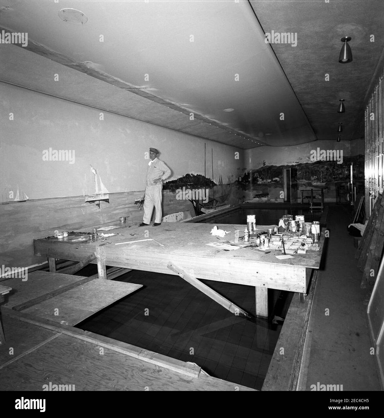 Bernard Lamotte painting White House Swimming Pool mural. Artist
