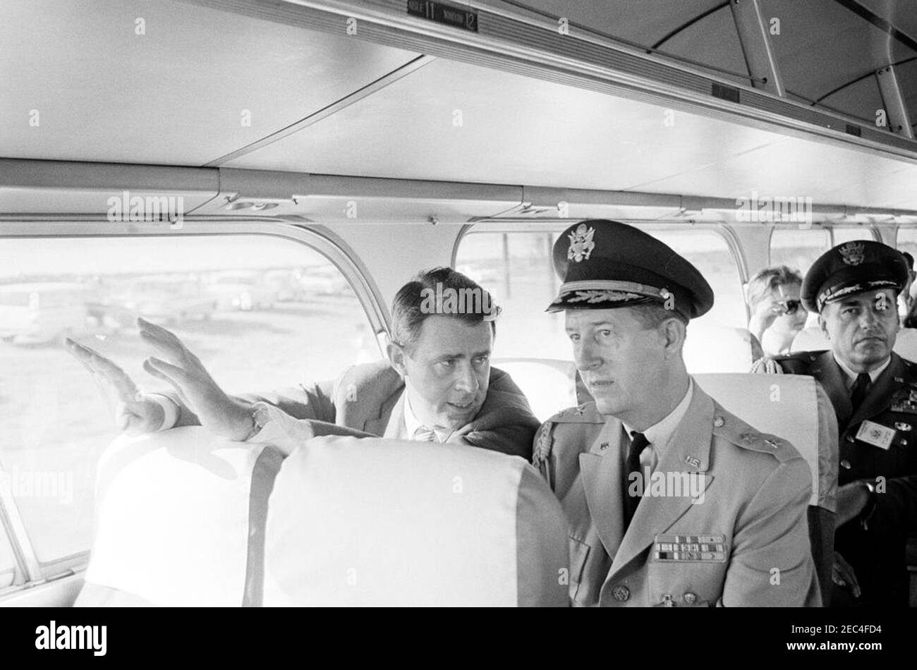 Inspection tour of NASA installations: Huntsville Alabama, Redstone Army Airfield and George C. Marshall Space Flight Center, 9:35AM. Secretary of the Army, Cyrus R. Vance, and Military Aide to the President, General Chester V. Clifton, sit on a bus, during President John F. Kennedyu0027s visit to Redstone Arsenal, Huntsville, Alabama, as part of a two-day inspection tour of National Aeronautics and Space Administration (NASA) field installations. Air Force Aide to the President, Brigadier General Godfrey T. McHugh, sits behind General Clifton. Stock Photo