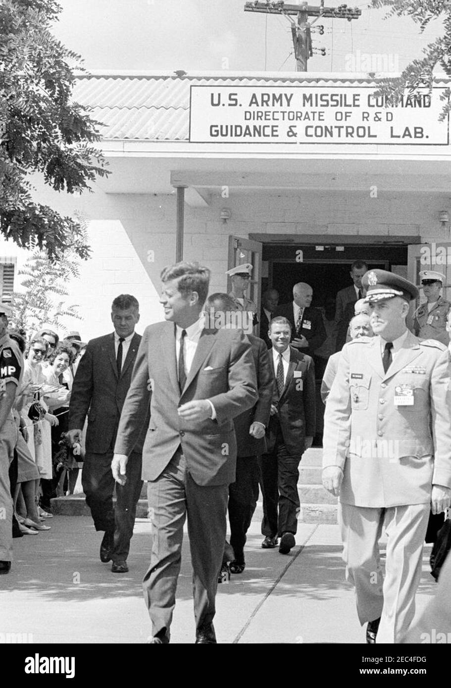 Inspection tour of NASA installations: Huntsville Alabama, Redstone Army Airfield and George C. Marshall Space Flight Center, 9:35AM. President John F. Kennedy walks with Commanding General of the U.S. Army Missile Command, Major General Francis J. McMorrow (right), following a tour of the U.S. Army Missile Command Guidance and Control Laboratory at Redstone Arsenal, Huntsville, Alabama. Also pictured: Vice President Lyndon B. Johnson; Secretary of Defense, Robert S. McNamara; Minister of Defence of Great Britain, Peter Thorneycroft; Secretary of the Air Force, Eugene M. Zuckert; Director of t Stock Photo