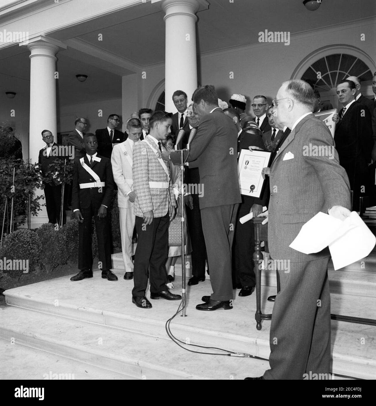 Presentation of the American Automobile Association (AAA) Lifesaving Awards in the Rose Garden, 9:50AM. President John F. Kennedy presents the American Automobile Association (AAA) Lifesaving Award to Ralph S. u201cSteveu201d Brannin (of North Pinellas Park, Florida); four other members of the organizationu2019s School Safety Patrol also received the award. Those pictured include: award recipients Wayne Brown (of New York, New York), Wesley Haines (of Dayton, Ohio), John Puhak (of Hazelton, Pennsylvania), and Patricia Miller (of Hereford, Pennsylvania); Representative Paul F. Schenck (Ohio) Stock Photo