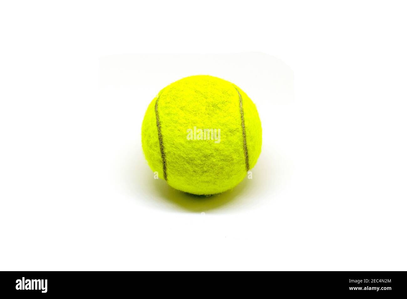 Tennis ball on white background. Isolated tennis ball. Yellow felt ball  with dark curve line and small shadow. Tennis game equipment. Sport and  active Stock Photo - Alamy