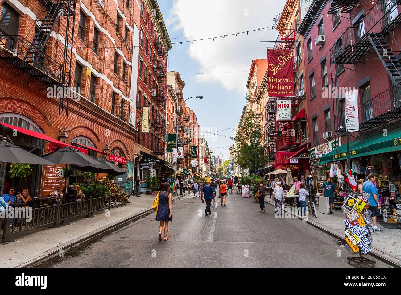 People walking by the Italian restaurants and shops on Mulberry Street, Little Italy in Lower Manhattan Stock Photo