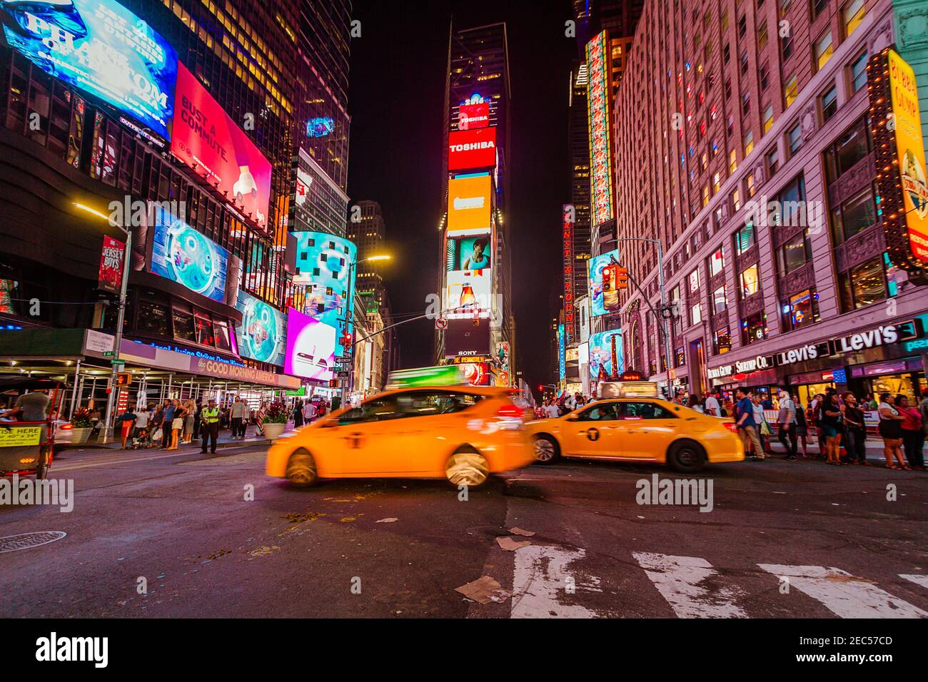 The northern view of Times Square with blurred cabs and tourists at night Stock Photo