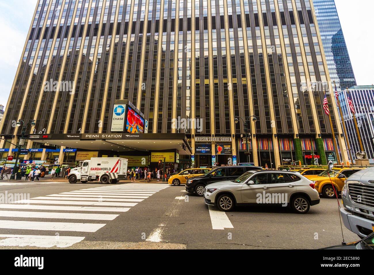 View of the Penn Station and the Madison Square Garden from the road in front of the entrance with traffic, cars and cabs Stock Photo
