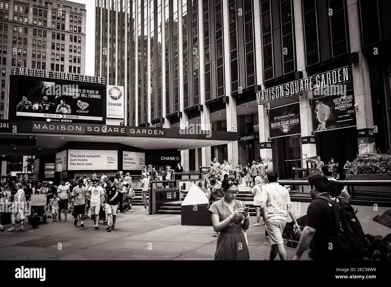 Black and white image of the entrance of the Madison Square Garden in New York with people walking Stock Photo